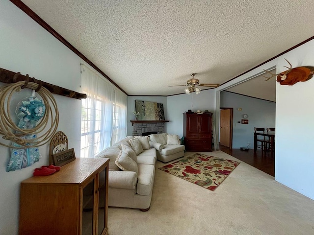 carpeted living room with ceiling fan, a textured ceiling, and ornamental molding