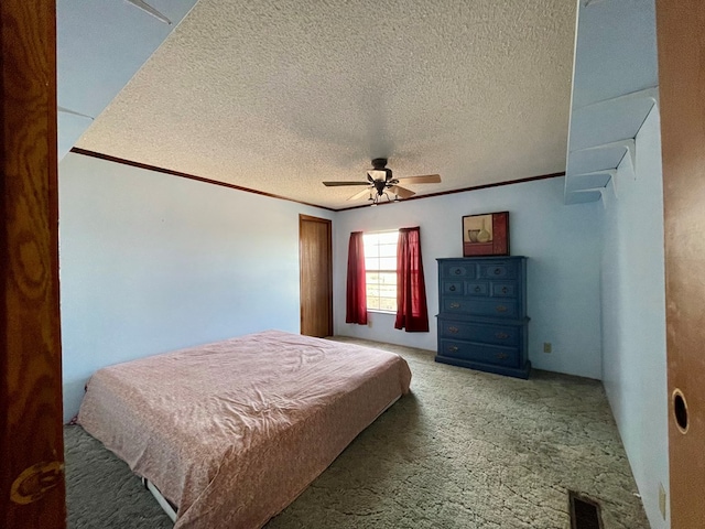 bedroom featuring carpet, ceiling fan, crown molding, and a textured ceiling