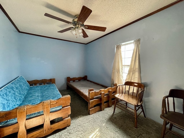 carpeted bedroom with a textured ceiling, ceiling fan, and ornamental molding