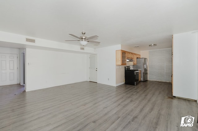 unfurnished living room with light wood-type flooring, visible vents, and ceiling fan