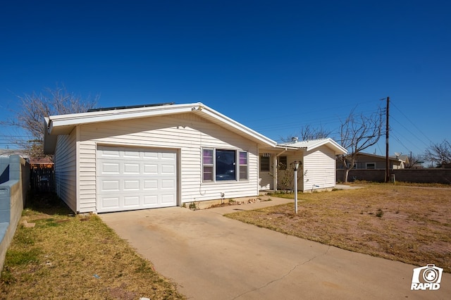 view of front of house with driveway, an attached garage, and fence