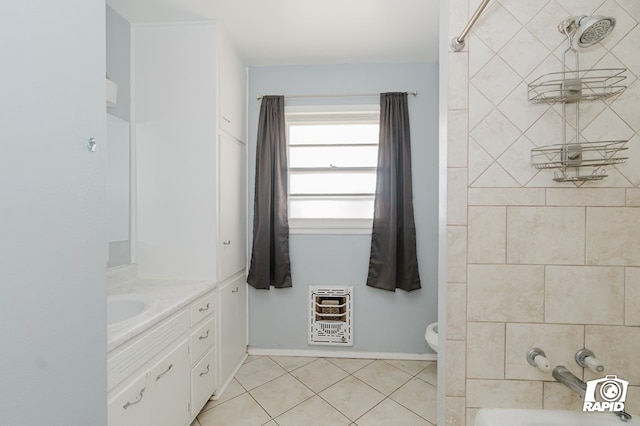 bathroom with toilet, vanity, tile patterned floors, heating unit, and shower / bathtub combination