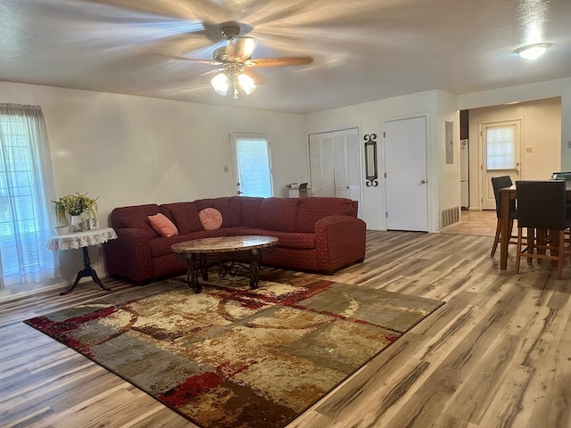 living room with hardwood / wood-style floors and ceiling fan