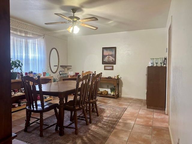 tiled dining area with ceiling fan