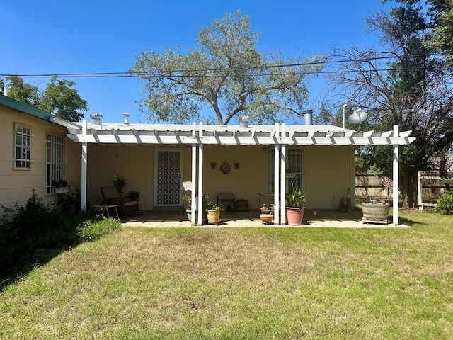 rear view of property with a yard, a patio, and a pergola