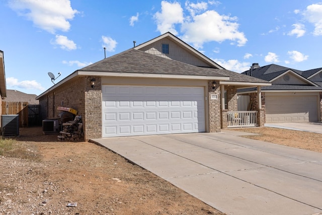 single story home with a garage and central air condition unit