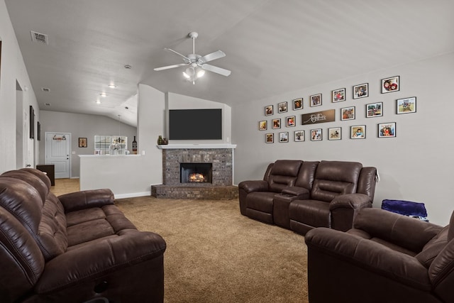 carpeted living room featuring a stone fireplace, ceiling fan, and lofted ceiling