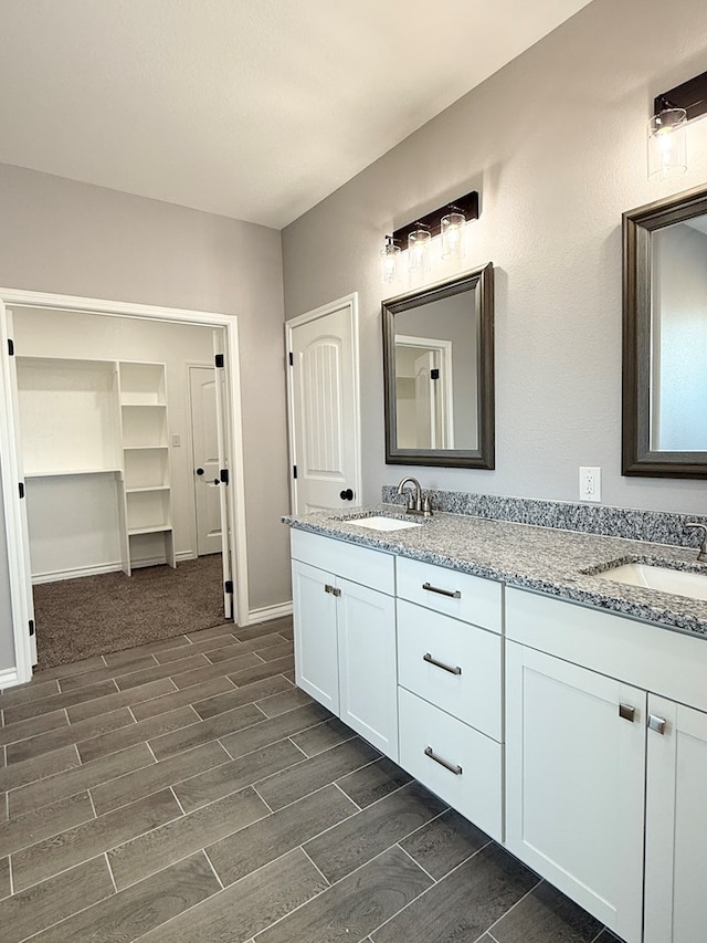 bathroom with vanity and hardwood / wood-style flooring