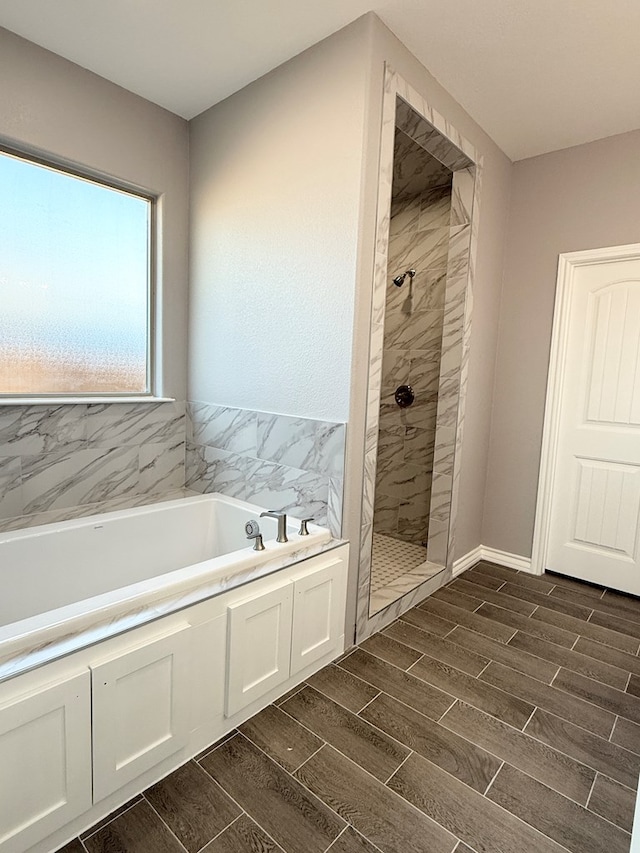 bathroom with shower with separate bathtub