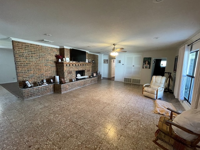 unfurnished living room with a textured ceiling, a brick fireplace, and ceiling fan