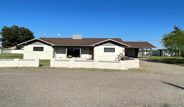 ranch-style house featuring a carport