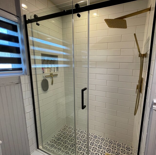 bathroom with a shower with door