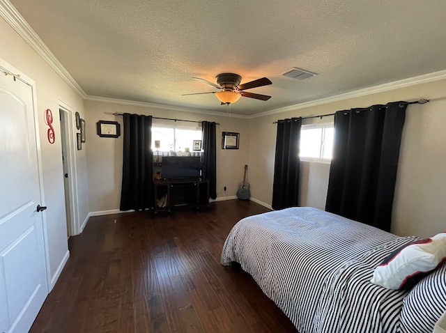 bedroom with ceiling fan, dark hardwood / wood-style flooring, ornamental molding, and a textured ceiling