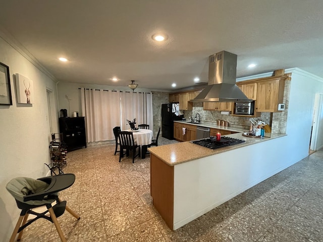 kitchen with backsplash, island exhaust hood, crown molding, kitchen peninsula, and black appliances