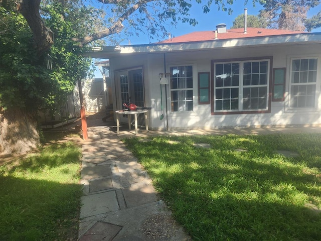 rear view of property with a yard