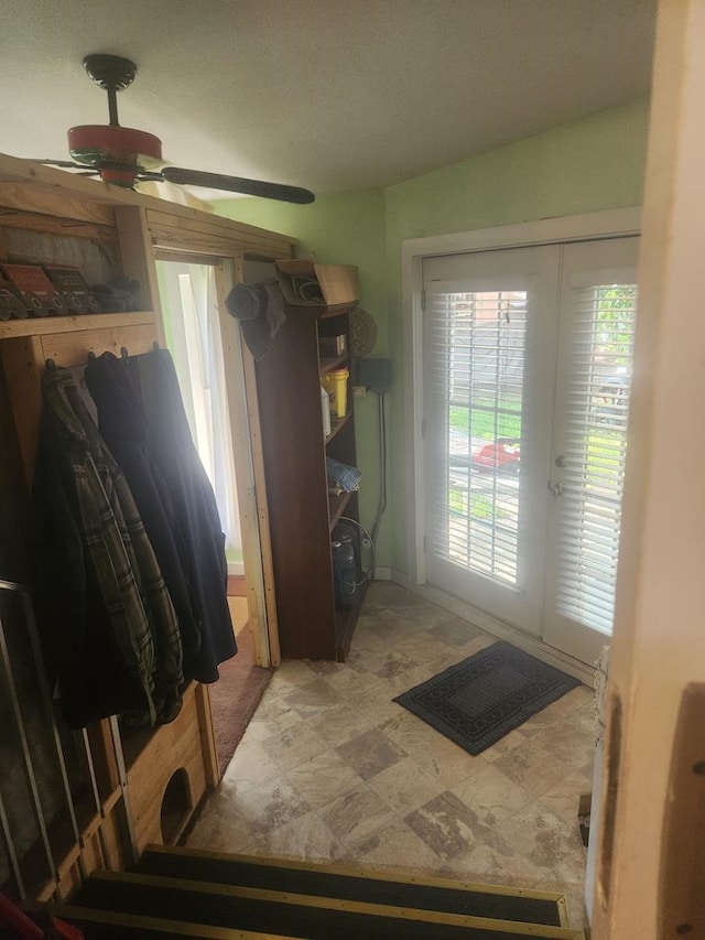 doorway to outside with ceiling fan and french doors