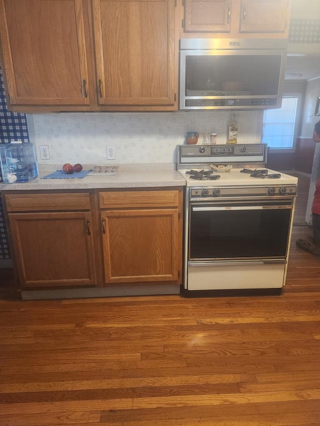 kitchen with dark hardwood / wood-style floors and white range