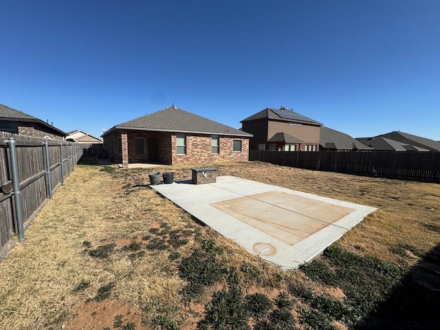 back of house featuring a lawn and a patio