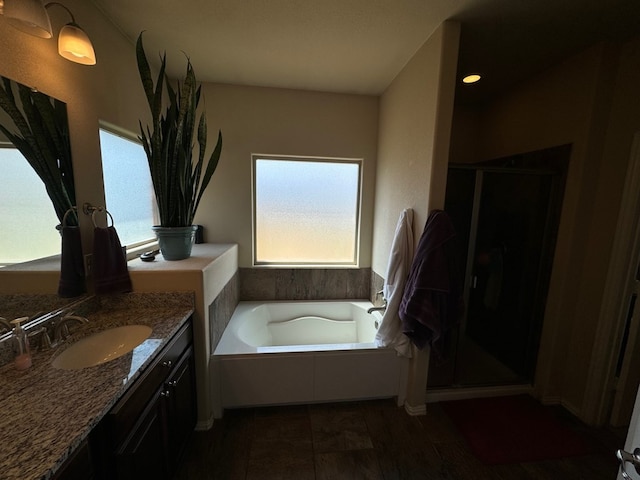 bathroom with independent shower and bath and vanity