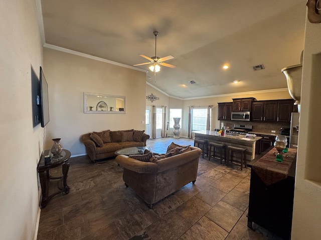 living room featuring ceiling fan, vaulted ceiling, and crown molding