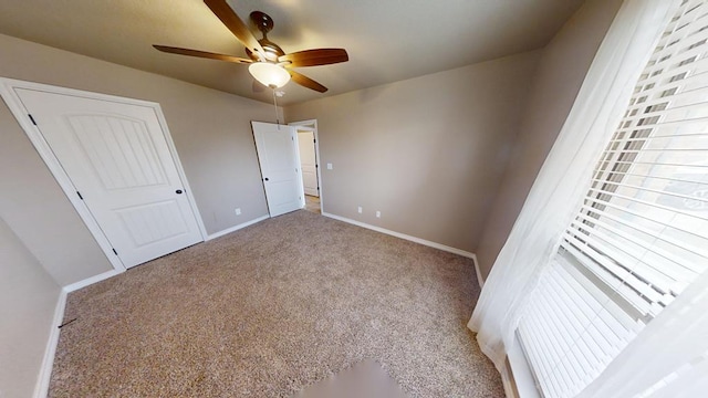 unfurnished bedroom featuring light carpet, ceiling fan, and baseboards