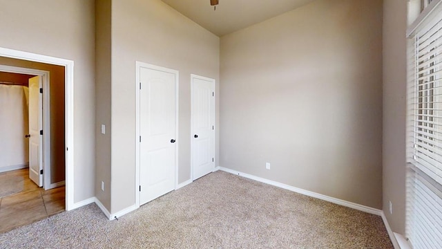 unfurnished bedroom featuring baseboards and carpet