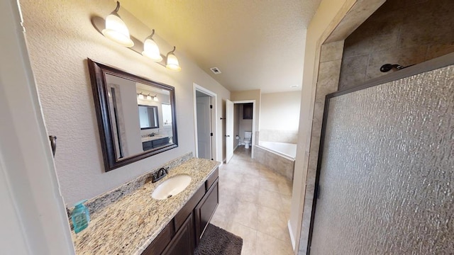 bathroom featuring vanity, visible vents, a tile shower, a garden tub, and tile patterned floors