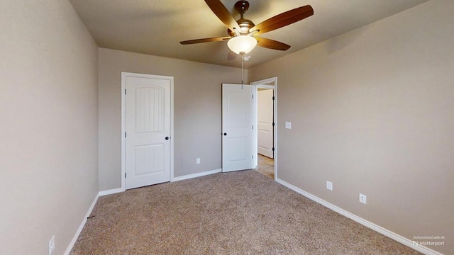 unfurnished bedroom featuring carpet, baseboards, and ceiling fan