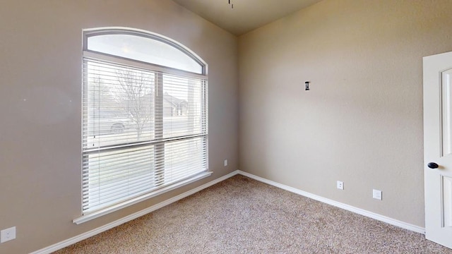 empty room featuring baseboards and carpet floors