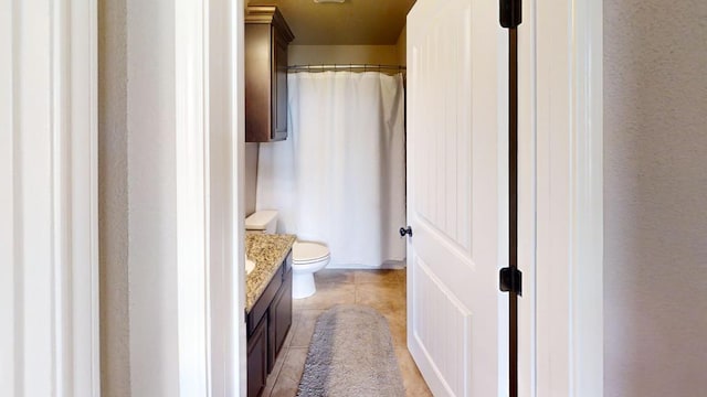 bathroom featuring tile patterned floors, toilet, and vanity