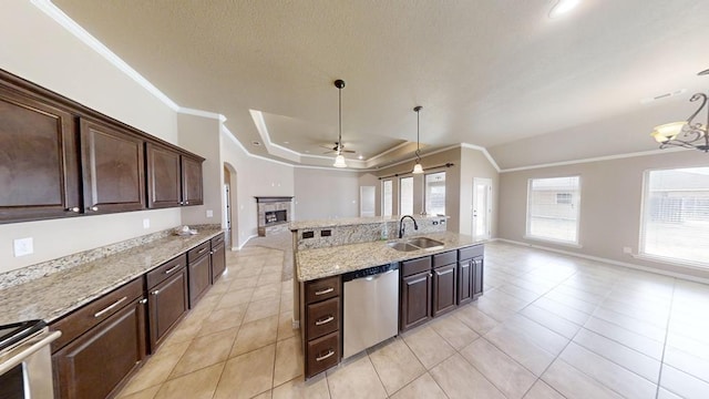 kitchen with a sink, ornamental molding, open floor plan, and stainless steel appliances