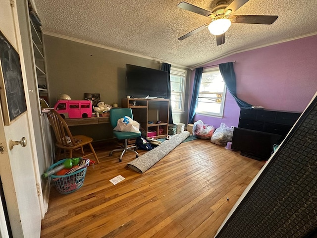 bedroom featuring ornamental molding, lofted ceiling, hardwood / wood-style floors, and a textured ceiling