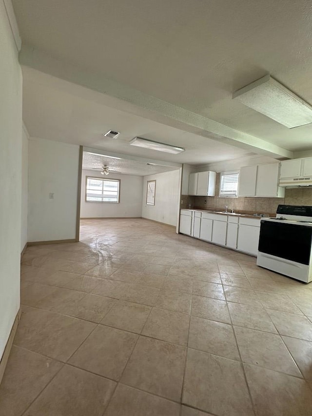 kitchen with backsplash, white range oven, ceiling fan, white cabinetry, and light tile patterned flooring