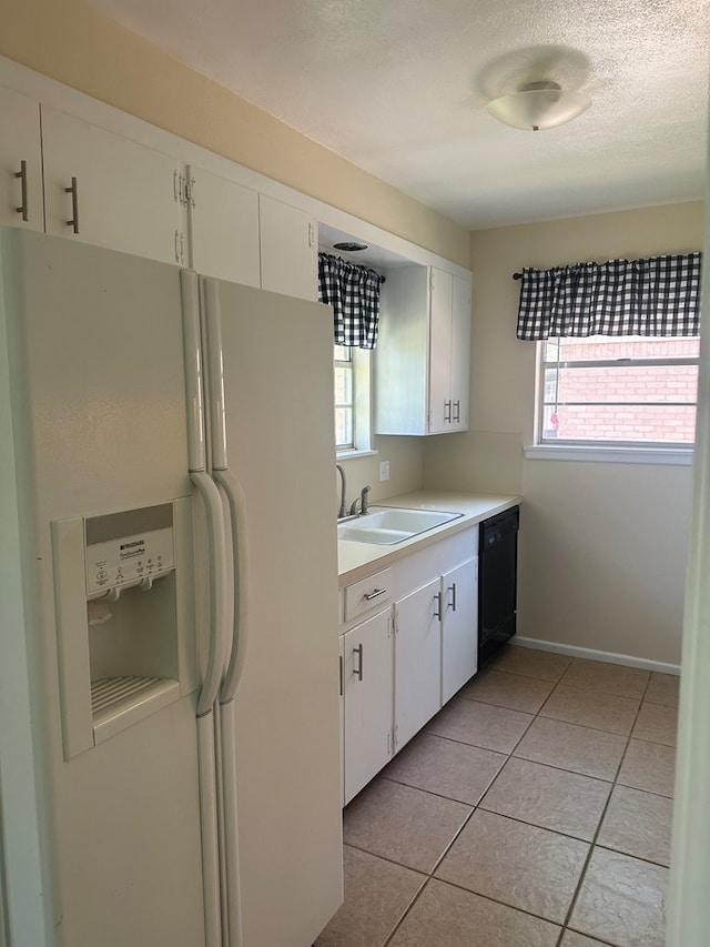 kitchen with white refrigerator with ice dispenser, a sink, white cabinetry, black dishwasher, and light countertops