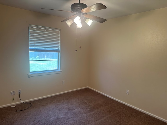 empty room featuring carpet, baseboards, and ceiling fan