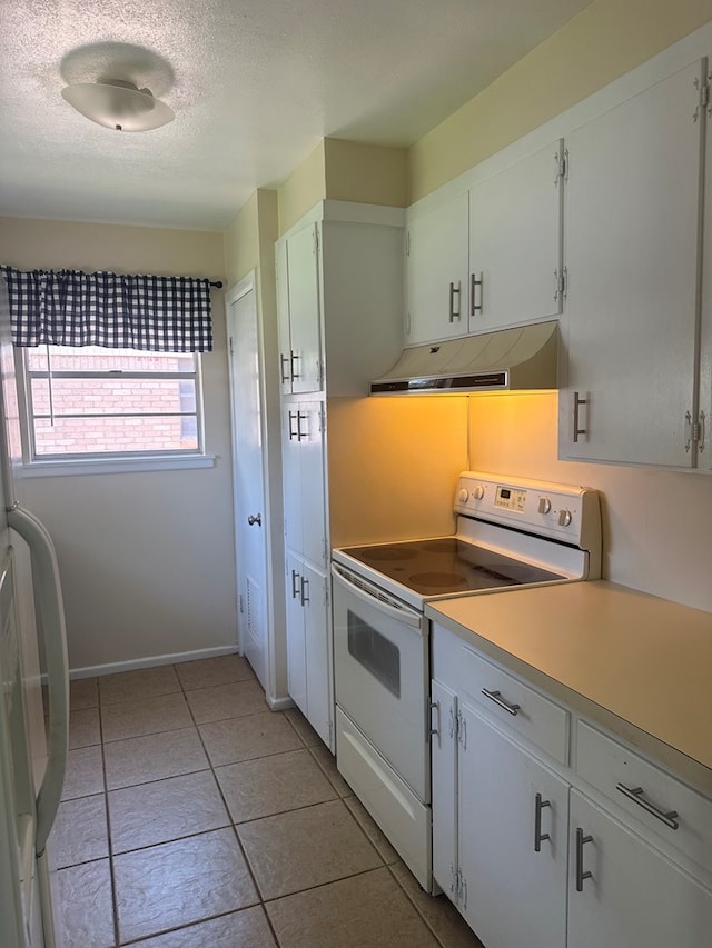 kitchen with a textured ceiling, under cabinet range hood, white appliances, white cabinets, and light countertops