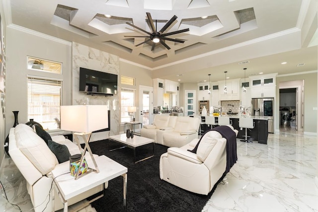 living room featuring a high ceiling, ornamental molding, ceiling fan, and coffered ceiling