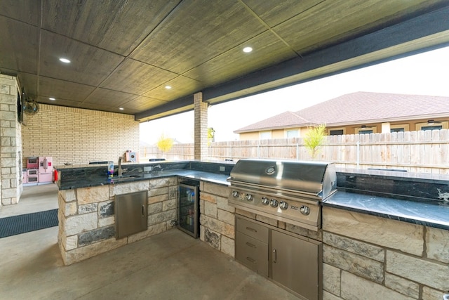 view of patio featuring sink, a grill, an outdoor kitchen, and wine cooler