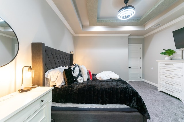 bedroom with ornamental molding, a raised ceiling, and carpet