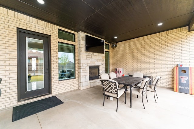 view of patio with an outdoor stone fireplace