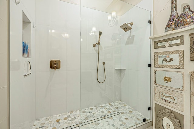 bathroom with a shower with door