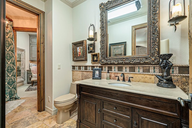 bathroom featuring crown molding, vanity, and toilet