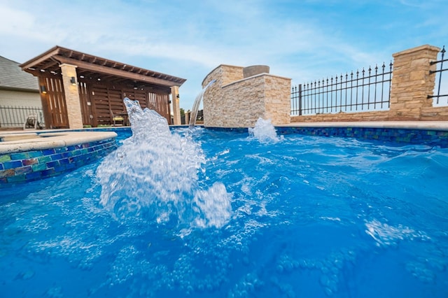 view of swimming pool featuring pool water feature