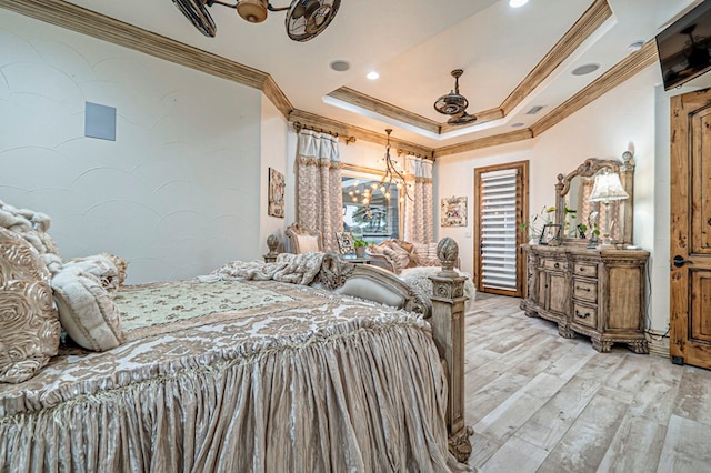 bedroom with light hardwood / wood-style floors, a raised ceiling, crown molding, and a chandelier