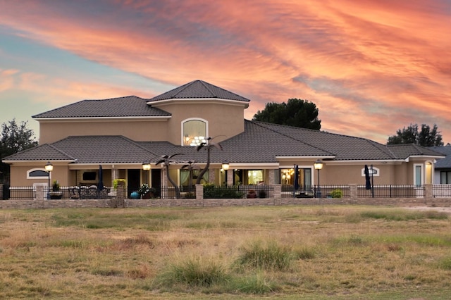 view of back house at dusk