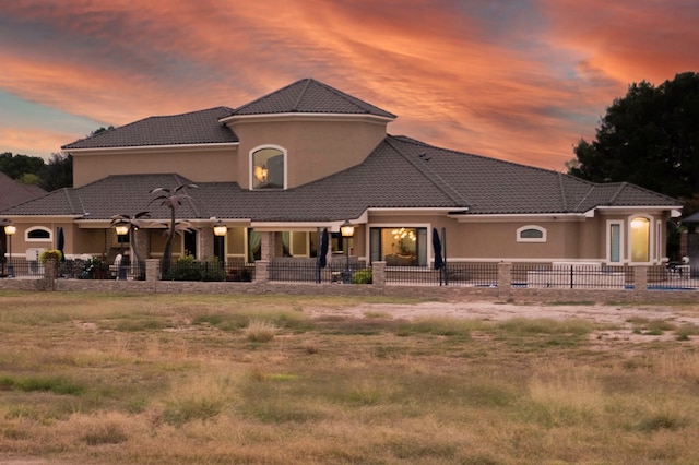 view of back house at dusk