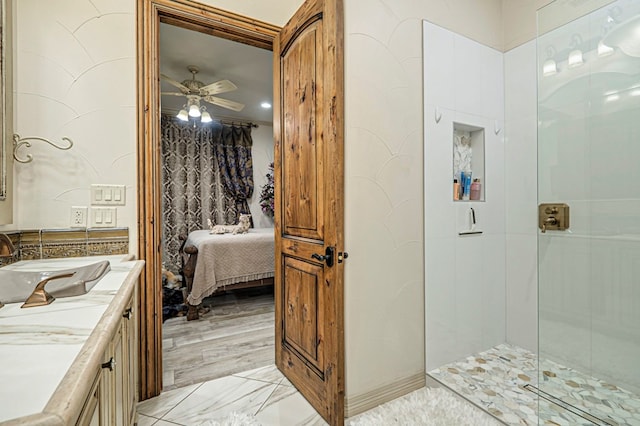 bathroom featuring vanity, ceiling fan, wood-type flooring, and walk in shower