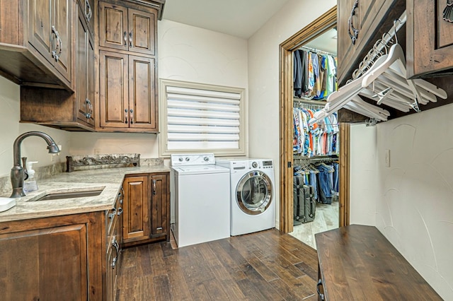 washroom featuring cabinets, washer and dryer, dark wood-type flooring, and sink