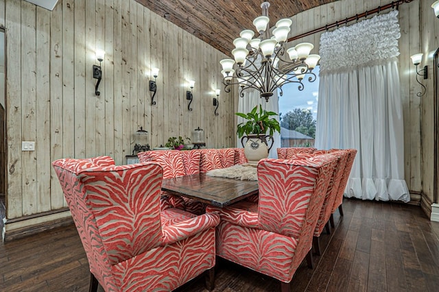 dining area with dark wood-type flooring, wood walls, a chandelier, vaulted ceiling, and wood ceiling