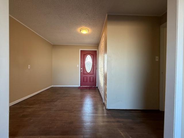 entrance foyer with a textured ceiling and dark hardwood / wood-style floors